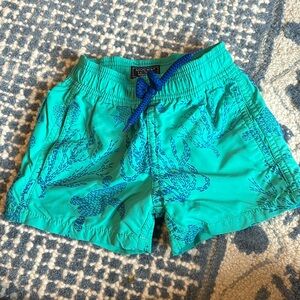 Vilberquin in green swim trunks